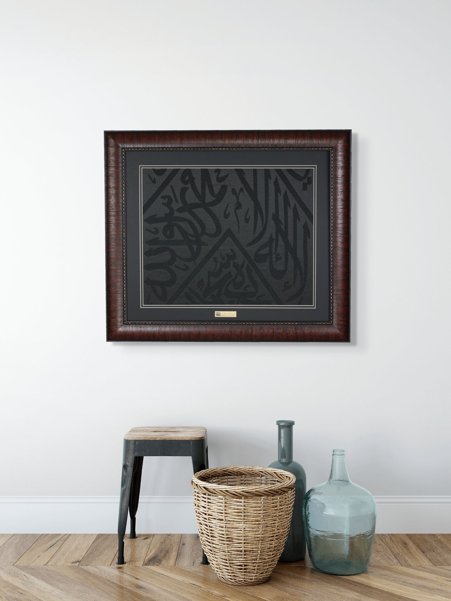 Framed artwork on a wall with decorative items on a wooden floor.